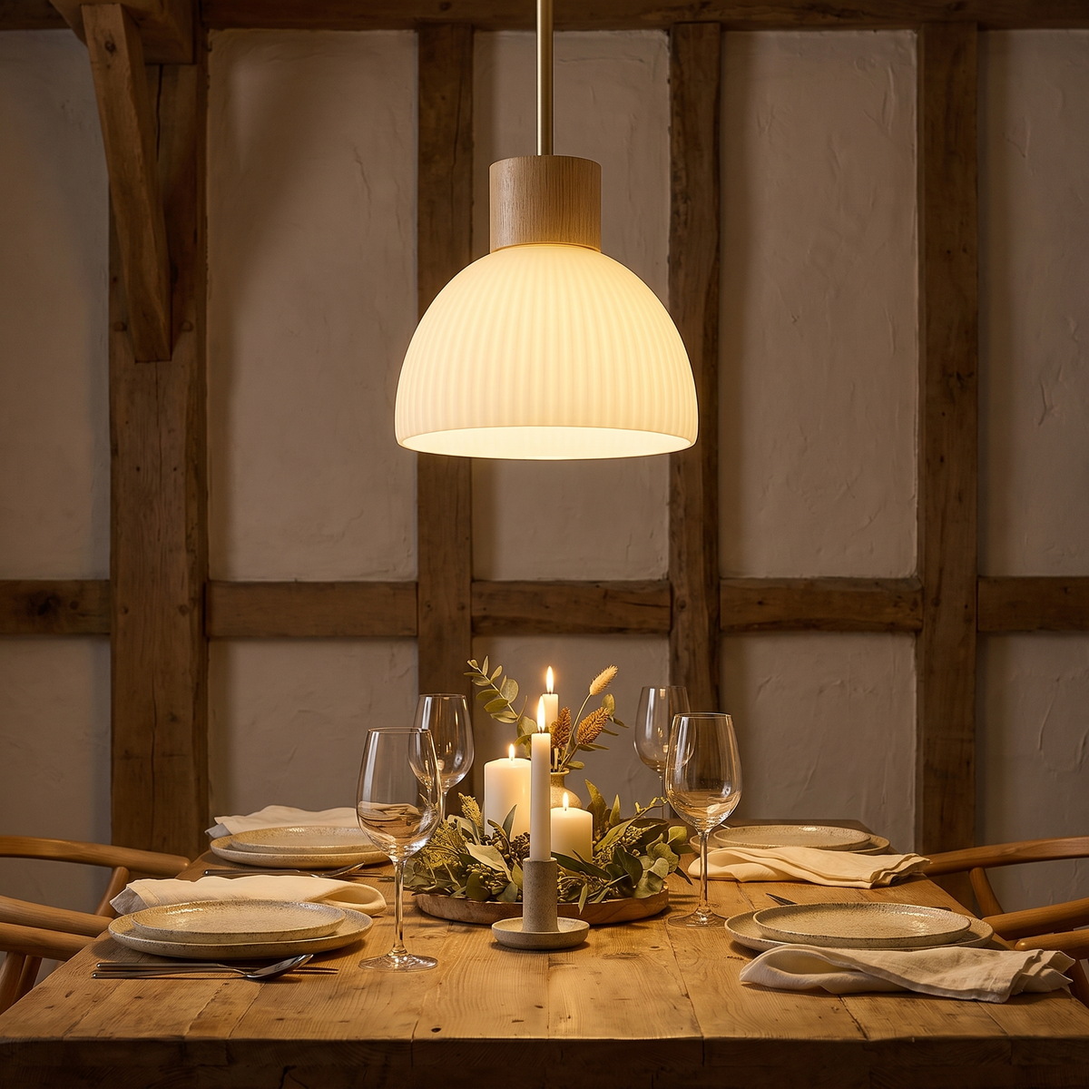 Wood and glass hanging lamp lit above a dining table in a warm interior
